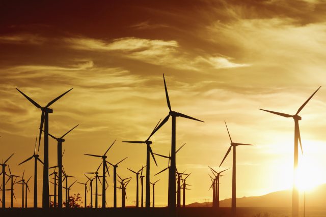 Image of wind farm in front of a setting sun