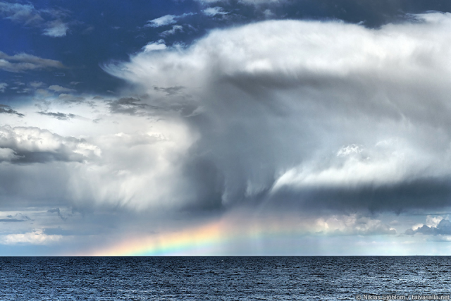 Rainclouds and a rainbow over the sea (Creative Commons; credit: Niklas Sjöblom)