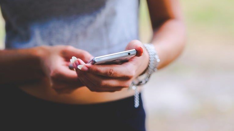 Image of girl using mobile phone: Increased access to social media, particularly via personal devices, presents opportunities but also risks (Image: Creative Commons Zero)