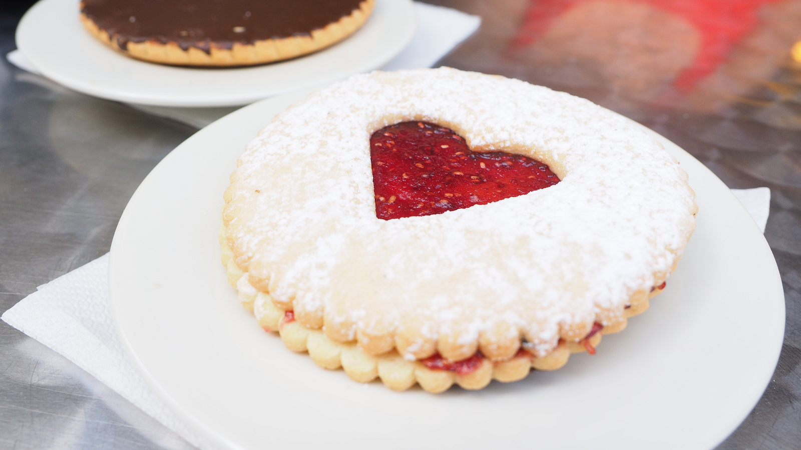 Image of a round biscuit with a jam heart in the middle