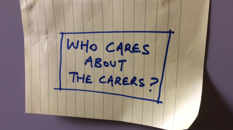 A note with writing which reads 'Who cares about the carers?'