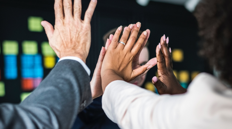 An image showing members of staff doing 'high fives'