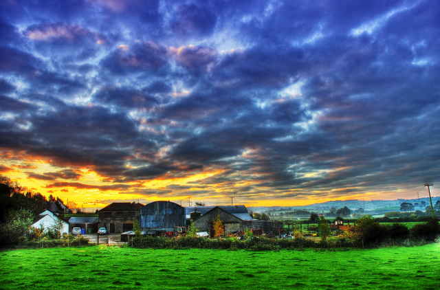 Image depicting a farm with a dramatic sky