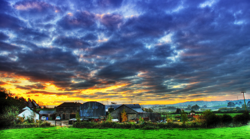 Image depicting a farm with a dramatic sky