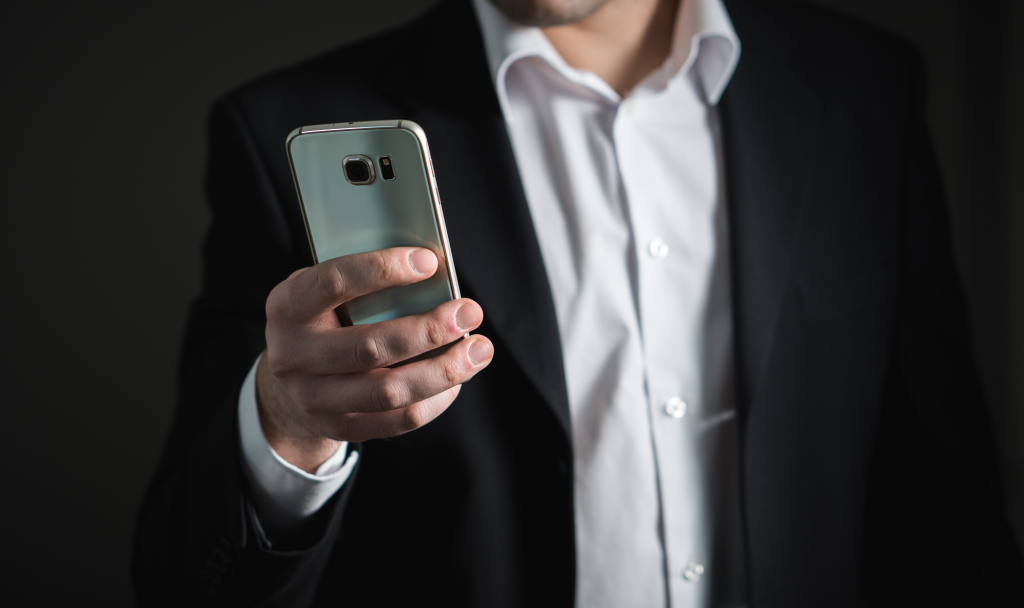 Image of a man holding a smartphone