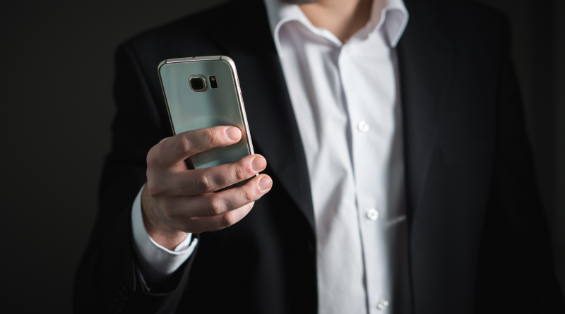 Image of a man holding a smartphone