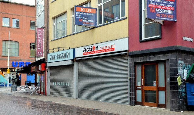 An image of closed shop units and 'To Let' signs