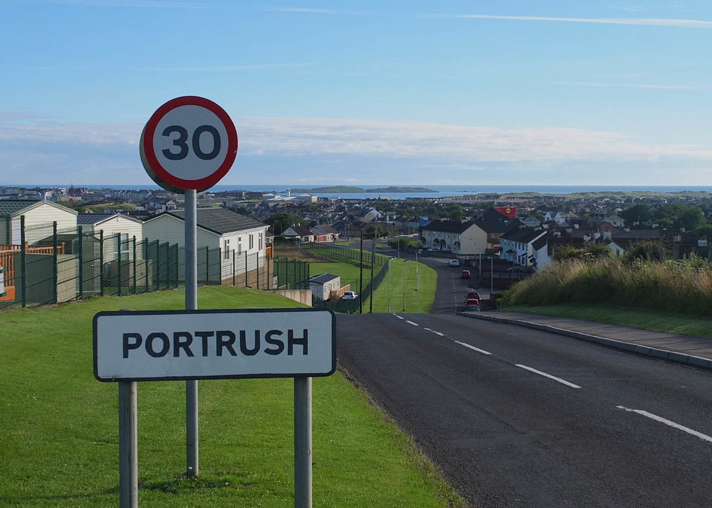 An image showing a road sign into Protrush, with the town in the background