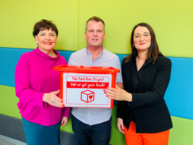 Image showing three people at the launch of the Red Box pilot: Brian Maguire North Belfast Primary Principals Support Programme, leader of the pilot project, Fionnula Torney (Business Support Officer, on the left), and Claire McKeown (Equality and Diversity Business Partner) from the ea’s Equality and Diversity Unit working in partnership with Brian Maguire from our School Improvement team, on the right)
