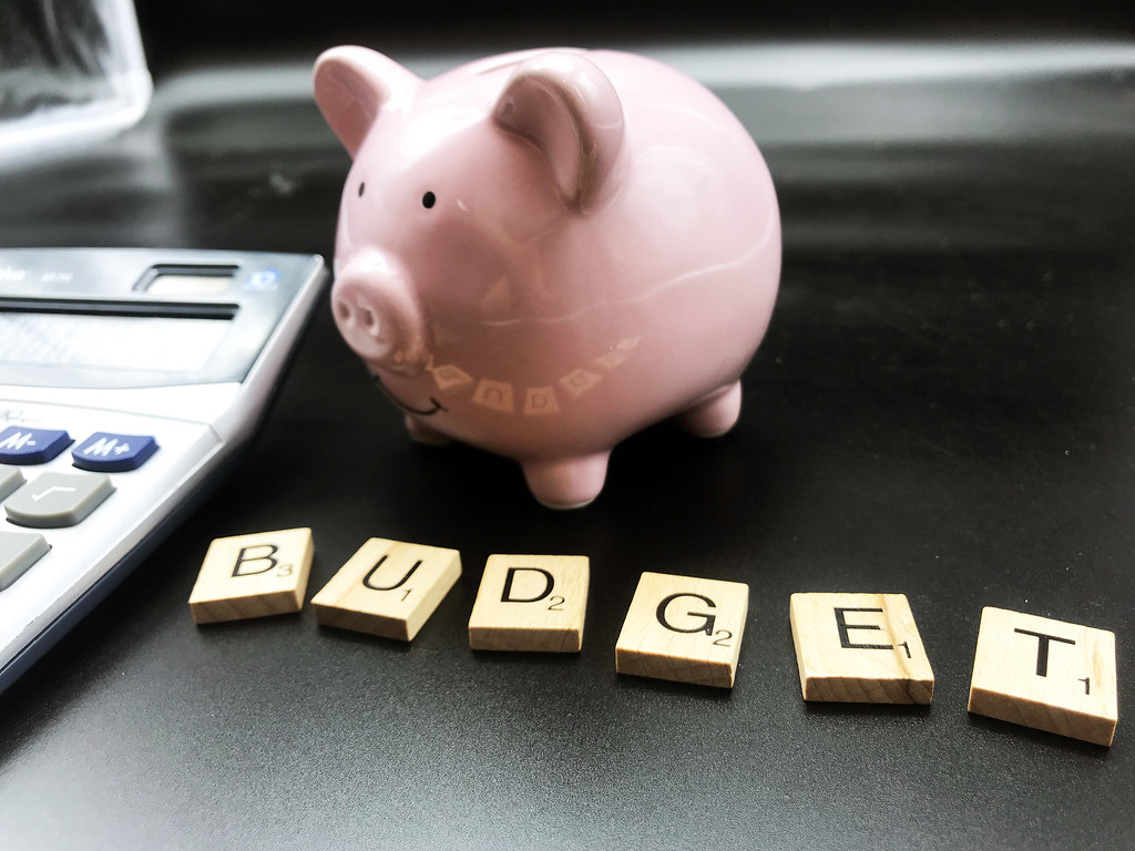 Image of piggy bank and scrabble tiles spelling out the word budget