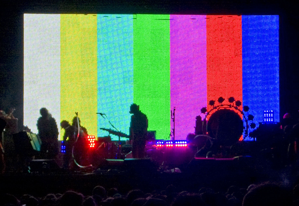 A colourful image of a band on stage at the Belsonic Festival, Belfast.