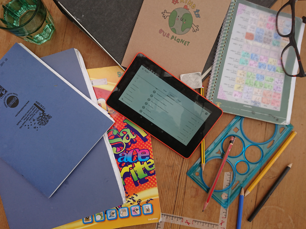 An image showing some school books and other material as part of home-schooling