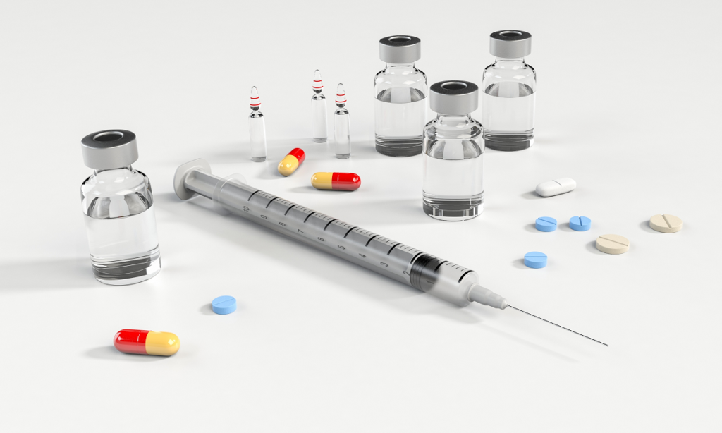 An image showing a syringe and a range of medicines