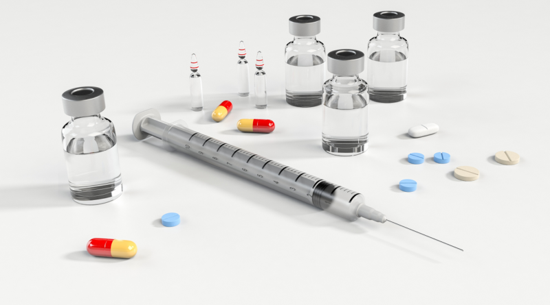 An image showing a syringe and a range of medicines