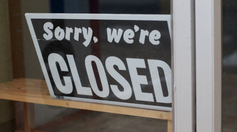 An image showing a shop sign that says 'Sorry, we're closed'