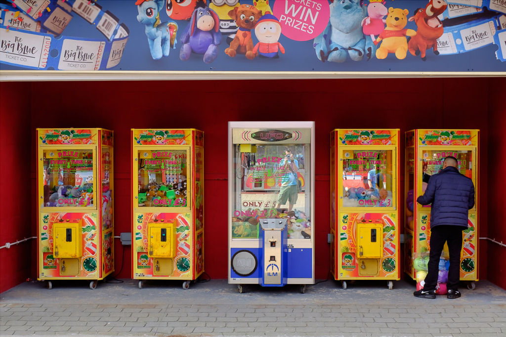 An image showing some crane grab machines at a fairground