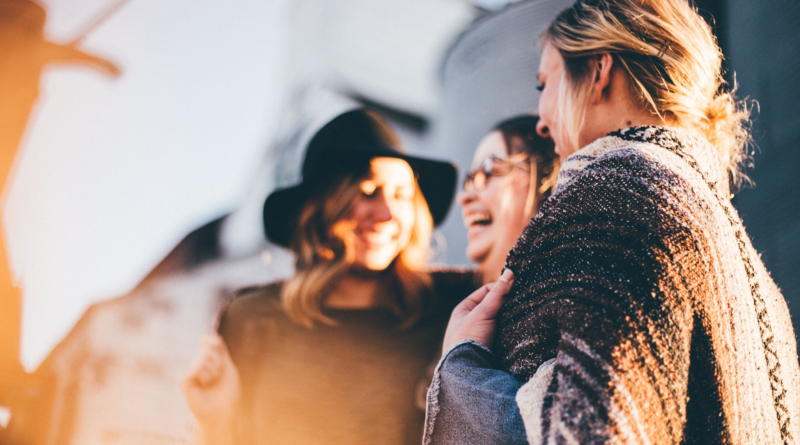 An image showing a group of women talking and laughing