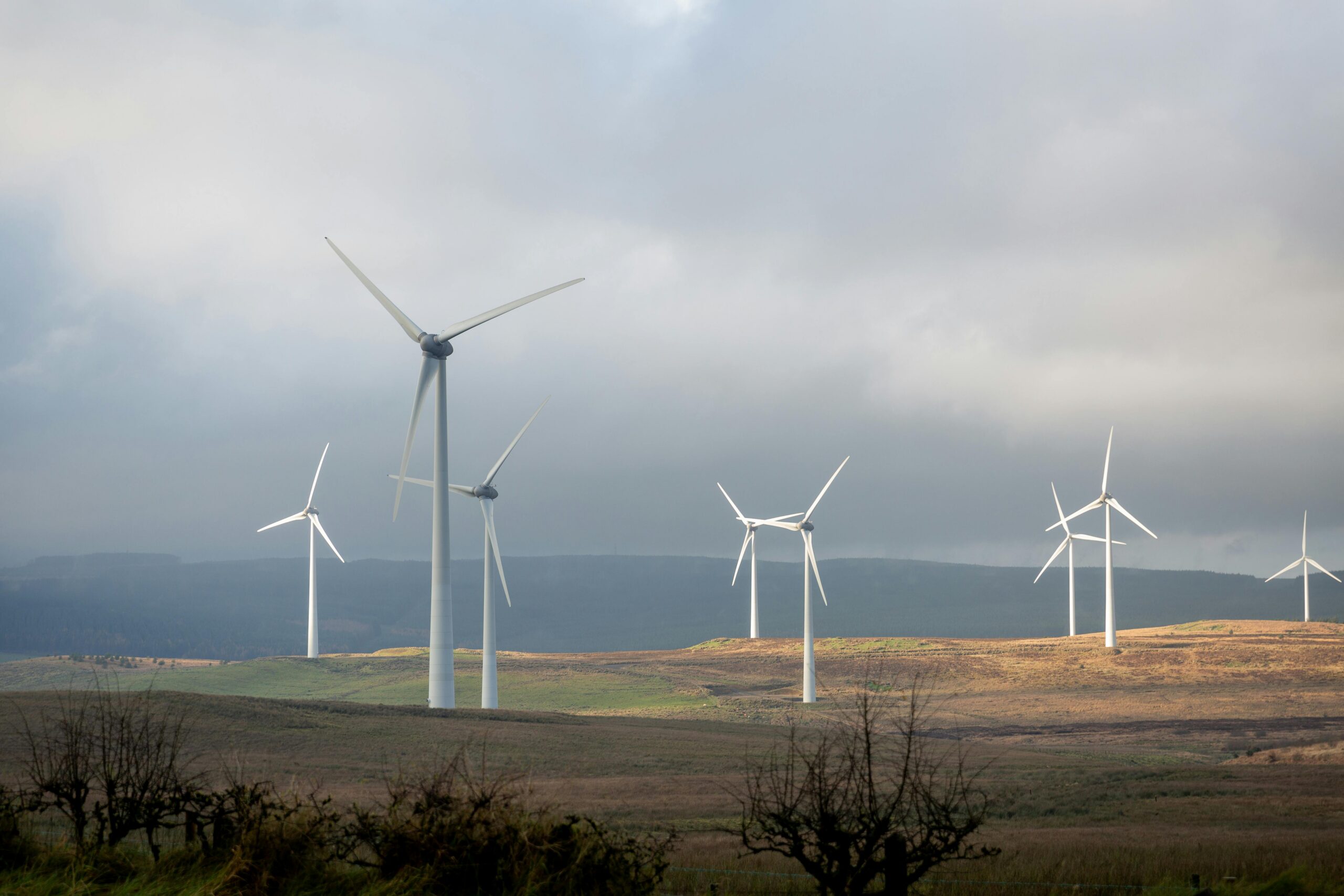 A photograph showing a set of white-coloured wind turbines on some hills in Northern Ireland