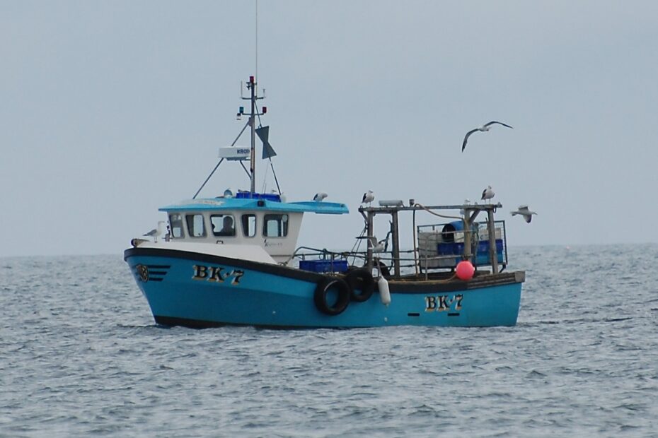 A photograph showing a small fishing vessel at sea